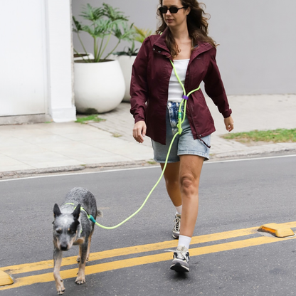 Woman walking a dog with hands-free leash in an urban setting