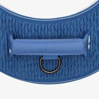 Blue dog harness with a handle on a white background