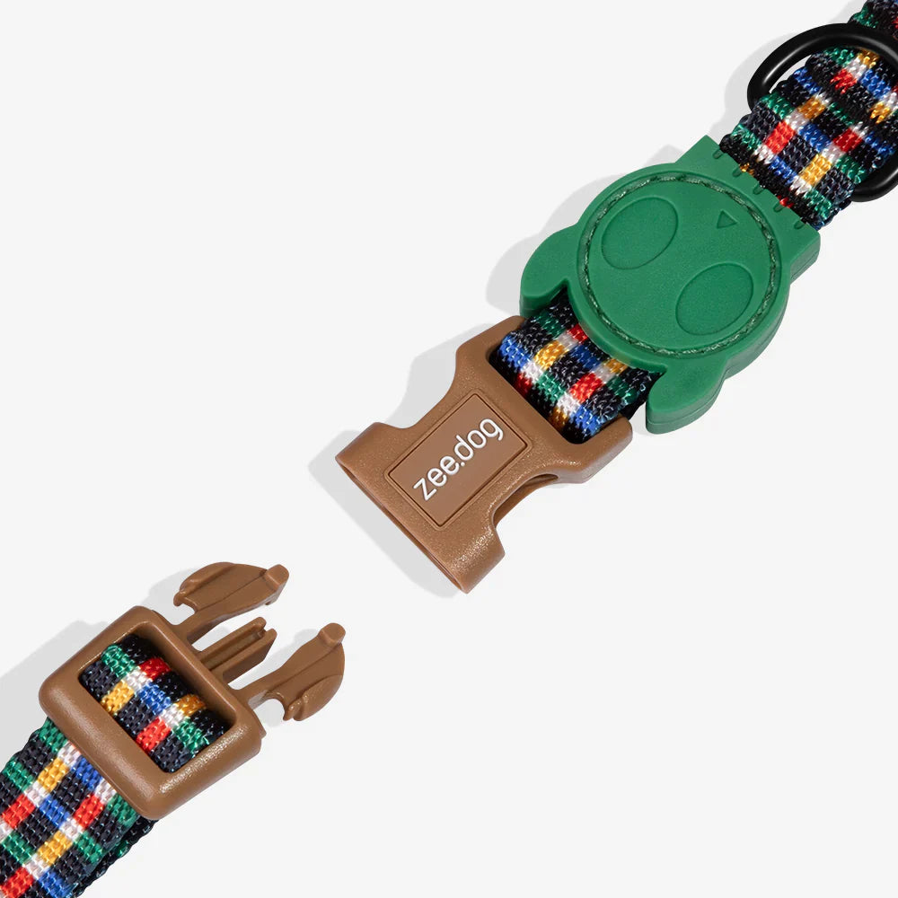 Dog collar with colorful strap and green and brown buckles on a white background