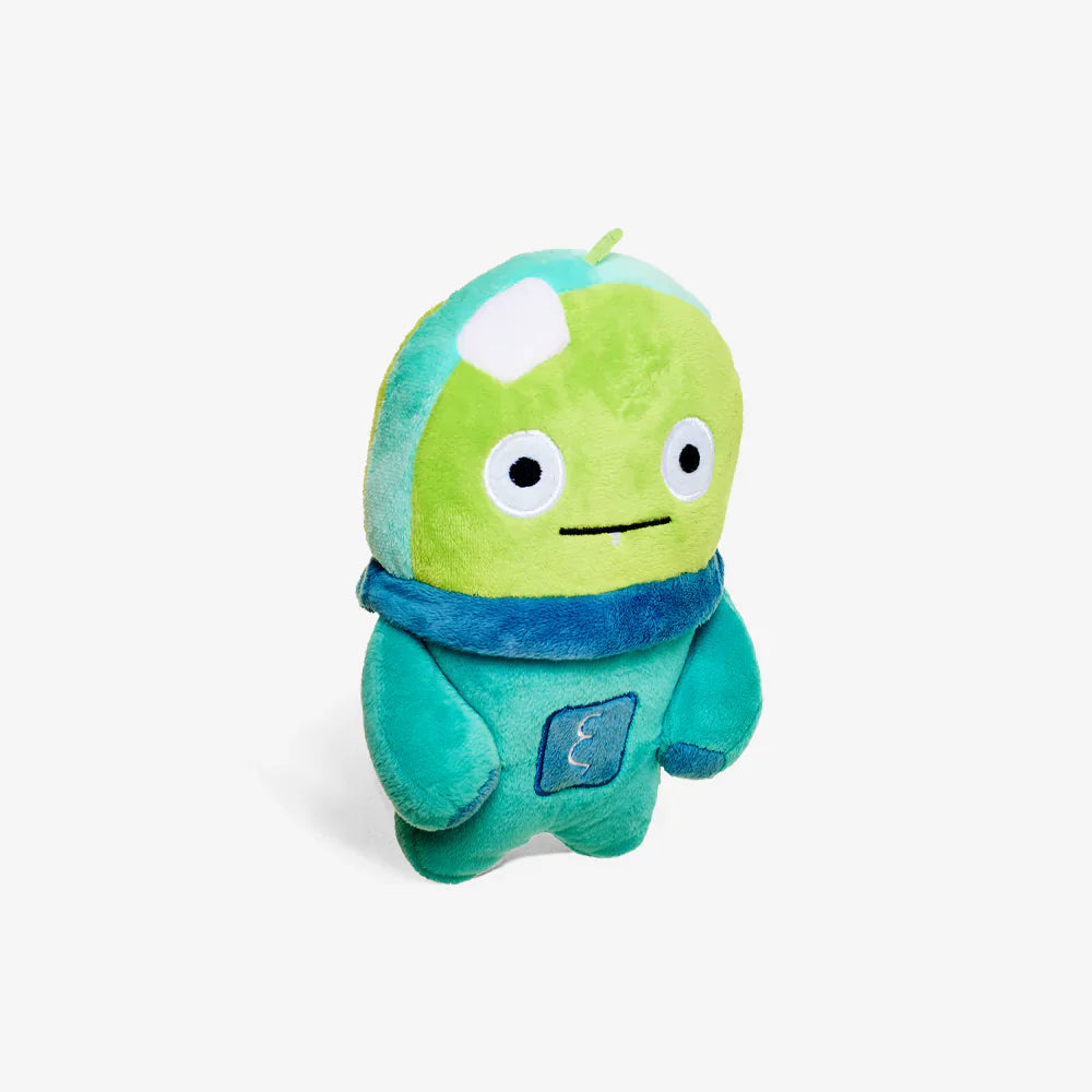 Green and blue plush toy on a light grey background