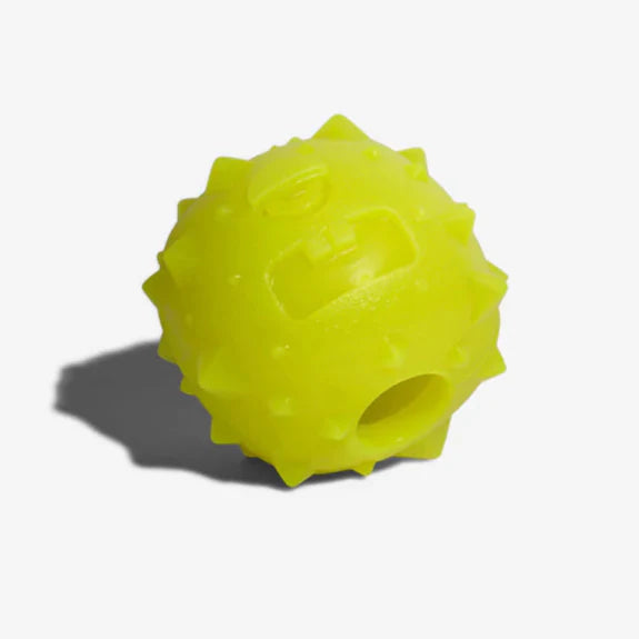 Rob the microbe toy on its side showing the treat dispenser's hole