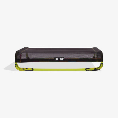 Black and green air bed on a white background