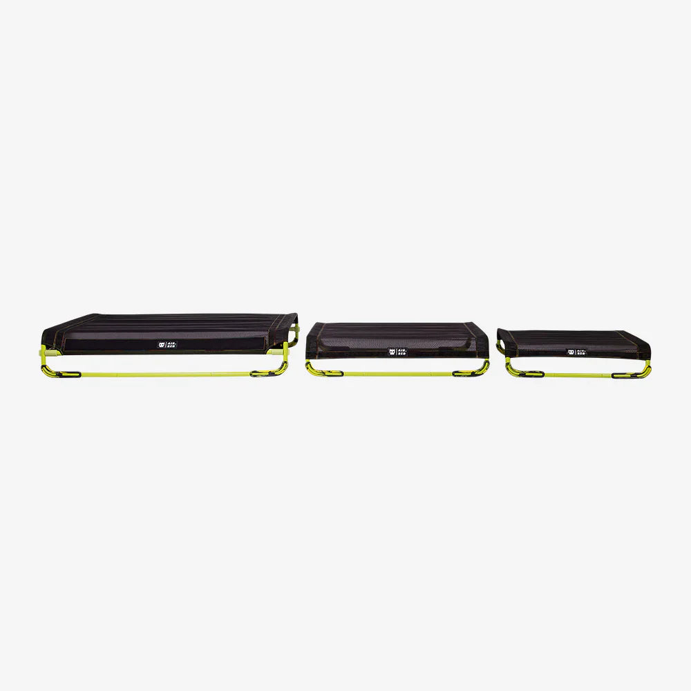 Three black and yellow air beds on a white background