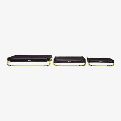 Three black and yellow air beds on a white background