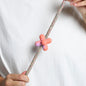 abstract rubber pinz with hands on a rope lead and white t shirt