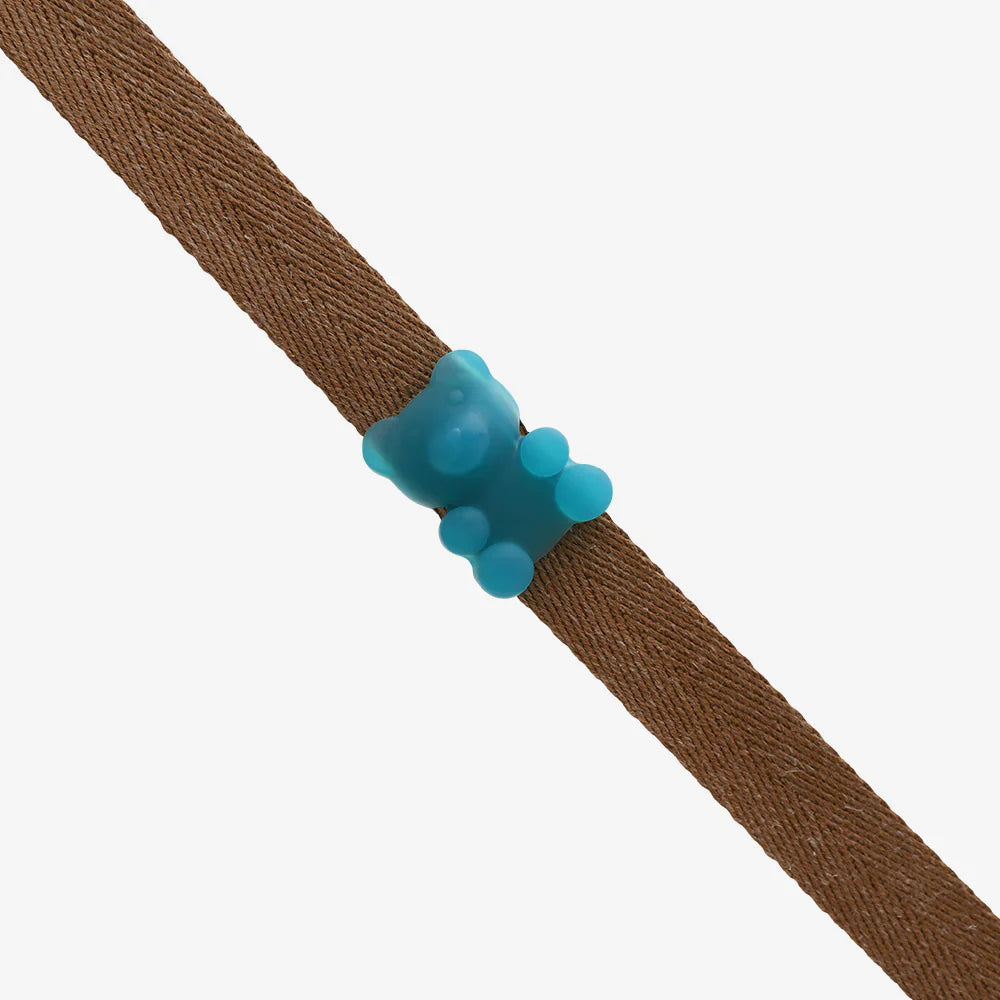 Brown lead with a blue gummy bear charm on a white background