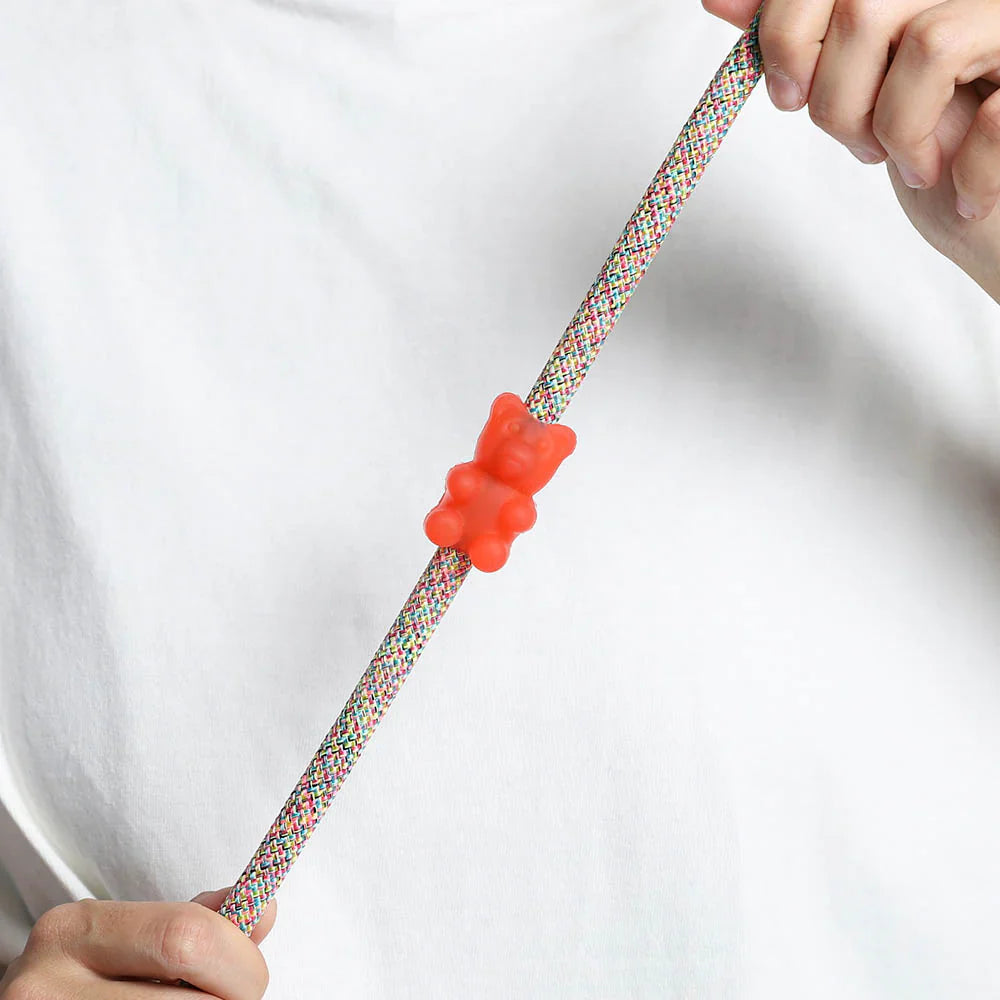 red gummy bear rubber pinz with hands on a rope lead and white t shirt